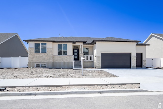 3077 N 2875 W Unit 5, Plain City, UT 84404 - view of front of property with a porch, fence, an attached garage, stone siding, and driveway