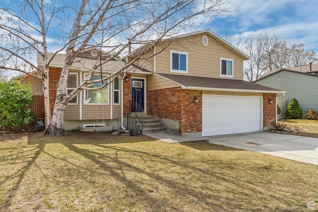 tri-level home featuring entry steps, concrete driveway, a front yard, a garage, and brick siding