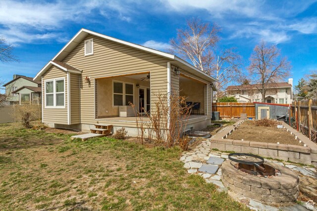 817 W Lucky Clover Ln, Murray, UT 84123 - exterior space featuring cooling unit, a fenced backyard, a lawn, and an outdoor fire pit