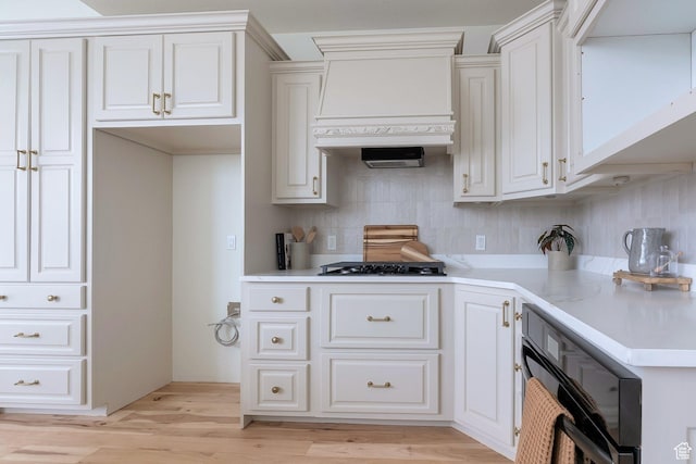 6264 W Skyline Dr N, Highland, UT 84003 - kitchen with light countertops, light wood-type flooring, custom exhaust hood, white cabinets, and decorative backsplash