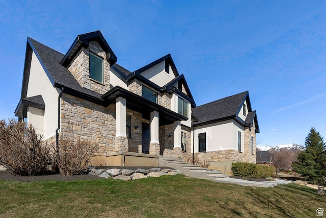 6264 W Skyline Dr N, Highland, UT 84003 - view of front of house with stone siding, stucco siding, a mountain view, and a front lawn