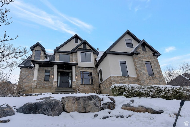 view of front of home featuring stone siding and stucco siding