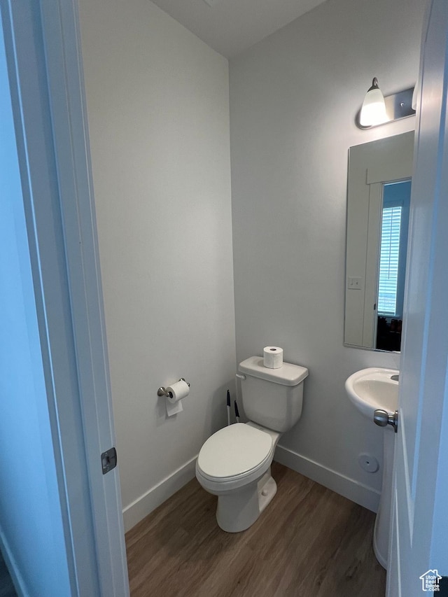 933 N 960 W Street W W 4, Tremonton, UT 84337 - bathroom featuring baseboards, wood finished floors, toilet, and a sink