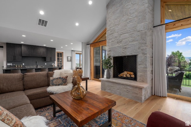 915 Farrell Farm Cir, Midway, UT 84049 - living room with visible vents, high vaulted ceiling, recessed lighting, a fireplace, and light wood-type flooring