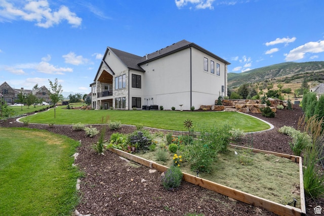 915 Farrell Farm Cir, Midway, UT 84049 - view of property exterior with a vegetable garden, a lawn, a mountain view, and stucco siding