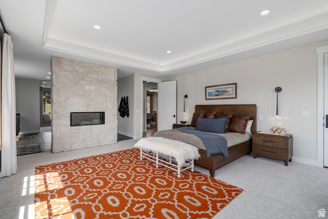 915 Farrell Farm Cir, Midway, UT 84049 - carpeted bedroom with a stone fireplace, a tray ceiling, recessed lighting, and baseboards