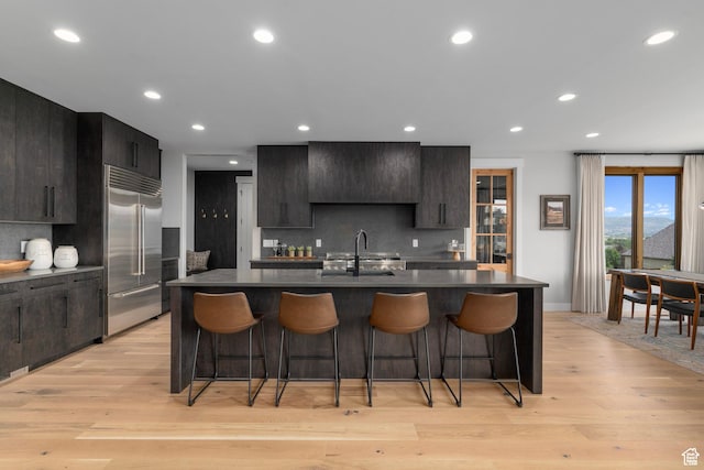 915 Farrell Farm Cir, Midway, UT 84049 - kitchen with a sink, dark countertops, a kitchen bar, and stainless steel built in fridge