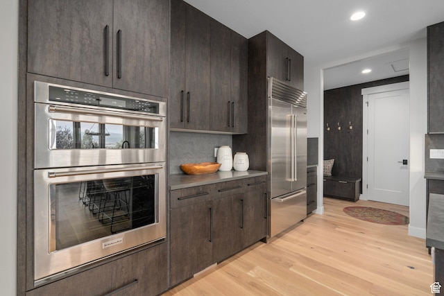 915 Farrell Farm Cir, Midway, UT 84049 - kitchen featuring dark brown cabinetry, recessed lighting, stainless steel appliances, and light wood-style floors