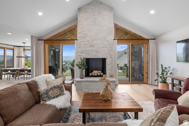 915 Farrell Farm Cir, Midway, UT 84049 - living area featuring recessed lighting, light wood-style floors, a stone fireplace, and vaulted ceiling