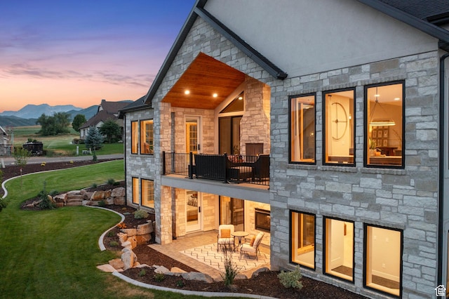 915 Farrell Farm Cir, Midway, UT 84049 - back of property with stone siding, a balcony, a lawn, and a patio