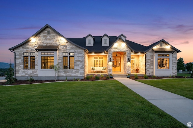 view of front of house featuring a front lawn and stone siding