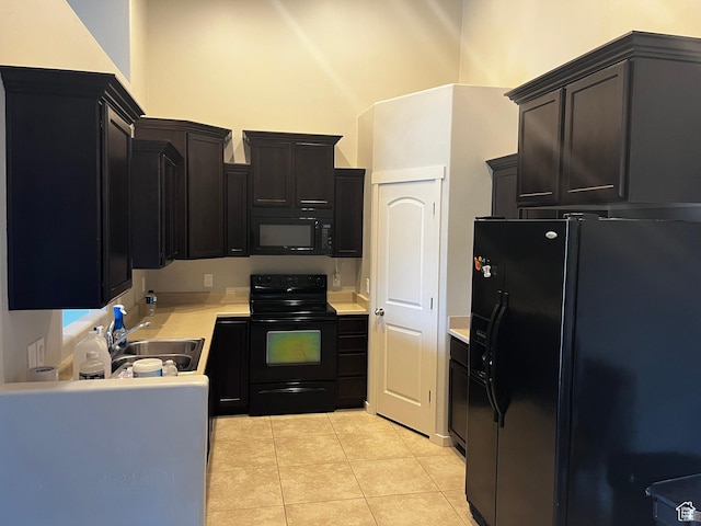 223 E Jordan Ridge Blvd Unit 110, Saratoga Springs, UT 84045 - kitchen featuring black appliances, a sink, dark cabinetry, light countertops, and light tile patterned floors