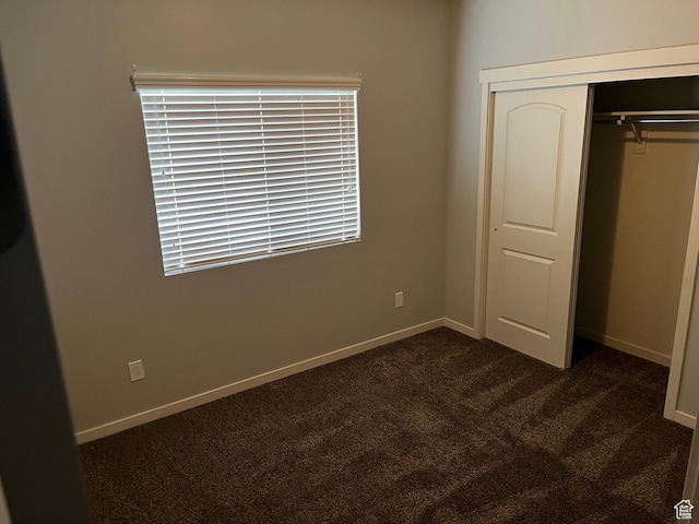 223 E Jordan Ridge Blvd Unit 110, Saratoga Springs, UT 84045 - unfurnished bedroom with a closet, baseboards, and dark colored carpet