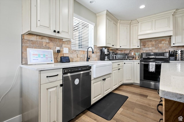 1490 N 4925 W, Plain City, UT 84404 - kitchen with light wood-type flooring, light stone counters, recessed lighting, appliances with stainless steel finishes, and decorative backsplash