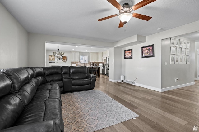 1490 N 4925 W, Plain City, UT 84404 - living room with wood finished floors, a ceiling fan, baseboards, and visible vents