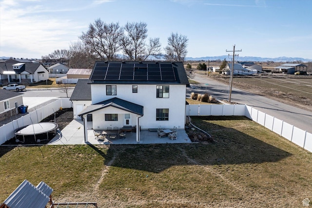 1490 N 4925 W, Plain City, UT 84404 - rear view of property featuring solar panels, a lawn, stucco siding, a fenced backyard, and a patio