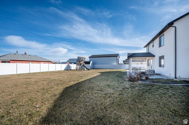1490 N 4925 W, Plain City, UT 84404 - view of yard featuring a patio area, a fenced backyard, and a playground