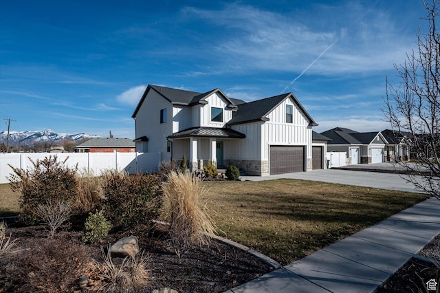 1490 N 4925 W, Plain City, UT 84404 - view of home's exterior with a standing seam roof, stone siding, fence, board and batten siding, and metal roof