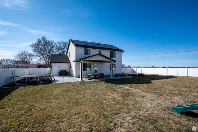 1490 N 4925 W, Plain City, UT 84404 - back of house featuring a trampoline, a patio area, a fenced backyard, and stucco siding