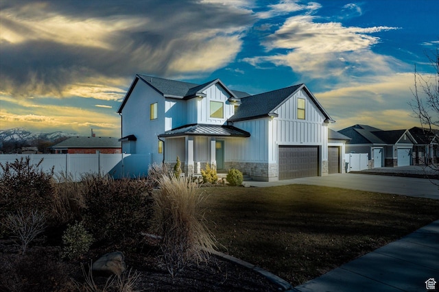 1490 N 4925 W, Plain City, UT 84404 - modern farmhouse style home featuring fence, a standing seam roof, an attached garage, board and batten siding, and metal roof