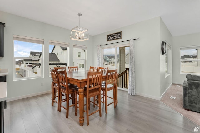 1843 E 970 N, Spanish Fork, UT 84660 - dining room featuring a healthy amount of sunlight, light wood finished floors, a notable chandelier, and baseboards
