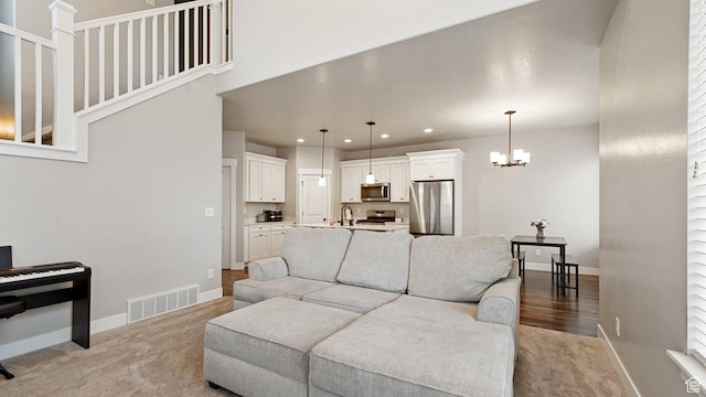 1606 N 4230 W, Lehi, UT 84043 - living area with visible vents, baseboards, light colored carpet, recessed lighting, and an inviting chandelier