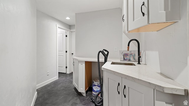 1606 N 4230 W, Lehi, UT 84043 - kitchen featuring white cabinets, light stone countertops, concrete flooring, and a sink