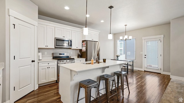 1606 N 4230 W, Lehi, UT 84043 - kitchen with dark wood finished floors, a center island with sink, a kitchen bar, and stainless steel appliances