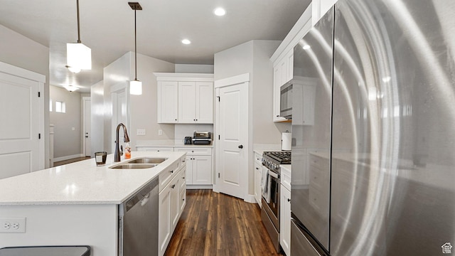 1606 N 4230 W, Lehi, UT 84043 - kitchen with a sink, an island with sink, stainless steel appliances, white cabinetry, and dark wood-style flooring