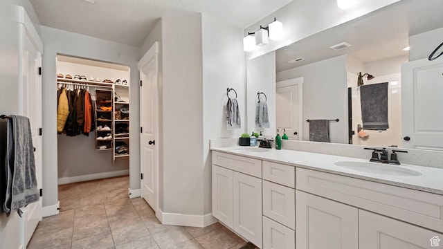 1606 N 4230 W, Lehi, UT 84043 - bathroom featuring tile patterned floors, double vanity, a walk in closet, and a sink