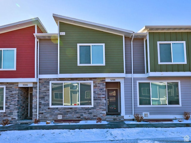 view of front of home with stone siding and board and batten siding