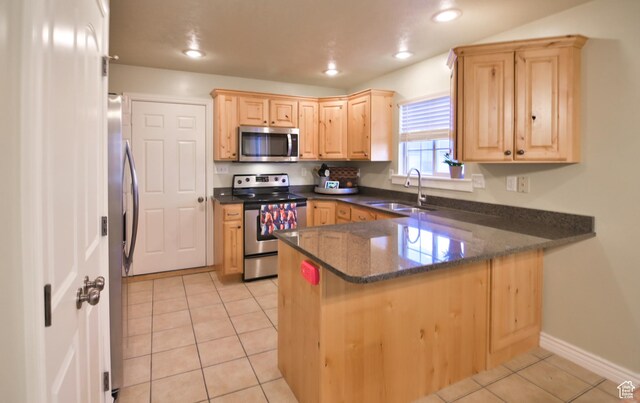3131 E River Bottoms Rd S, Spanish Fork, UT 84660 - kitchen with light tile patterned floors, a peninsula, light brown cabinetry, and stainless steel appliances