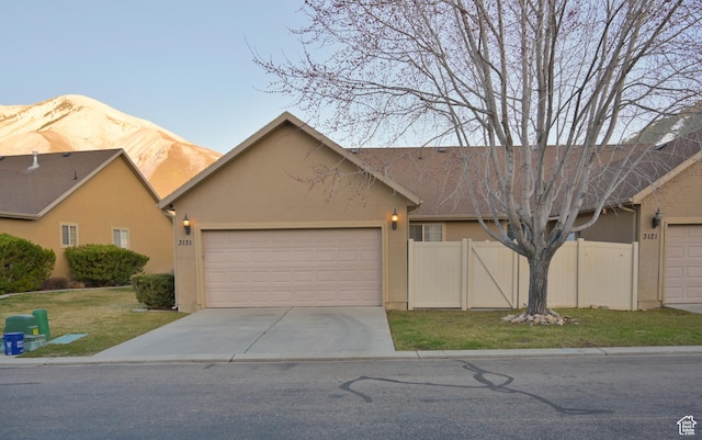 3131 E River Bottoms Rd S, Spanish Fork, UT 84660 - view of front facade featuring driveway, stucco siding, fence, and an attached garage