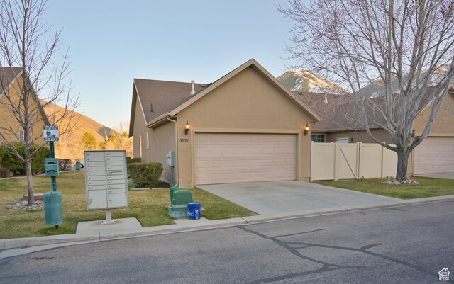 3131 E River Bottoms Rd S, Spanish Fork, UT 84660 - ranch-style home with stucco siding, fence, an attached garage, driveway, and a front yard