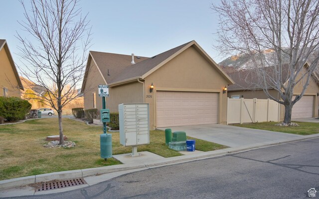 3131 E River Bottoms Rd S, Spanish Fork, UT 84660 - view of front of home with concrete driveway, stucco siding, fence, an attached garage, and a front lawn