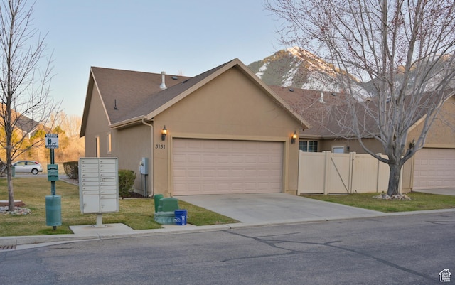 3131 E River Bottoms Rd S, Spanish Fork, UT 84660 - view of front of property featuring driveway, stucco siding, fence, an attached garage, and a shingled roof