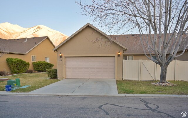 3131 E River Bottoms Rd S, Spanish Fork, UT 84660 - view of front of home with concrete driveway, stucco siding, fence, a front yard, and a garage