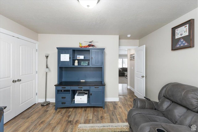 7114 N 2275 W, Honeyville, UT 84314 - living room with baseboards, a textured ceiling, and dark wood-style flooring
