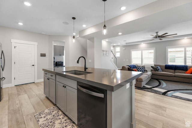 53 E Polaris Dr, Saratoga Springs, UT 84045 - kitchen with ceiling fan, a sink, appliances with stainless steel finishes, dark countertops, and light wood-type flooring