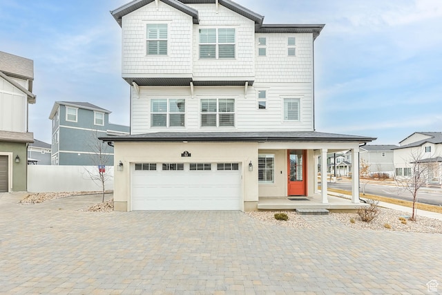 53 E Polaris Dr, Saratoga Springs, UT 84045 - view of front facade with decorative driveway, a garage, covered porch, and fence