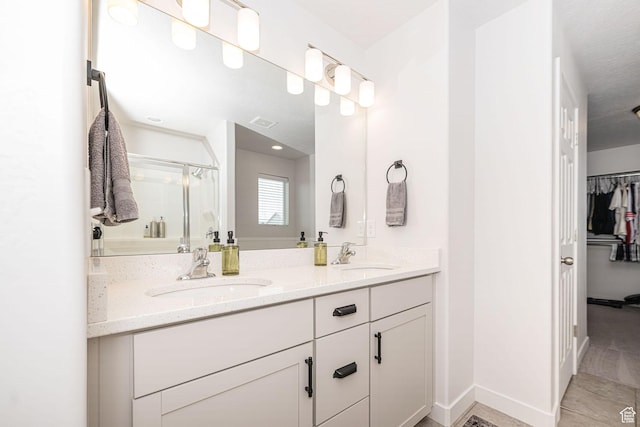 198 W Box Creek Dr, Stansbury Park, UT 84074 - bathroom featuring visible vents, a sink, a shower stall, and double vanity