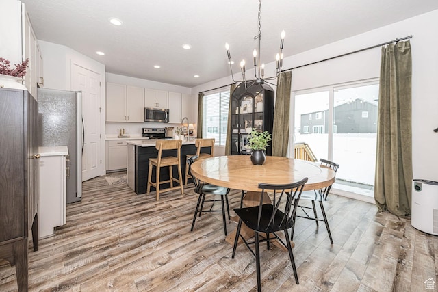 198 W Box Creek Dr, Stansbury Park, UT 84074 - dining space with recessed lighting, light wood-style flooring, and a notable chandelier
