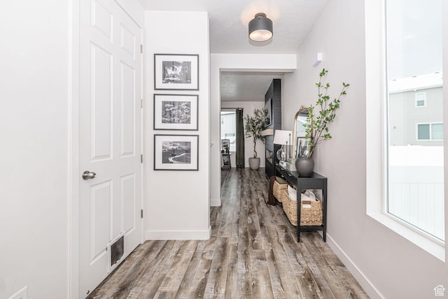 198 W Box Creek Dr, Stansbury Park, UT 84074 - corridor with wood finished floors, visible vents, and baseboards