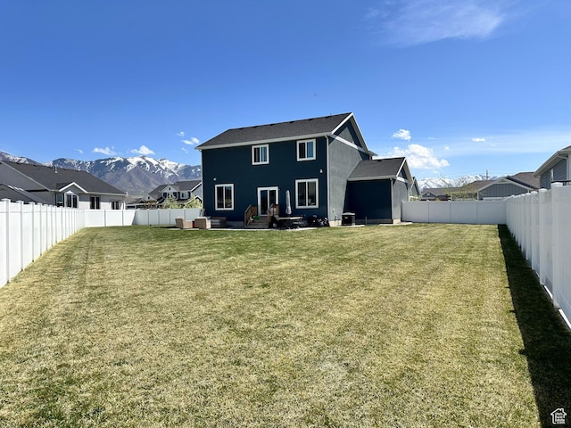 198 W Box Creek Dr, Stansbury Park, UT 84074 - rear view of house featuring a patio area, a lawn, a fenced backyard, and a mountain view
