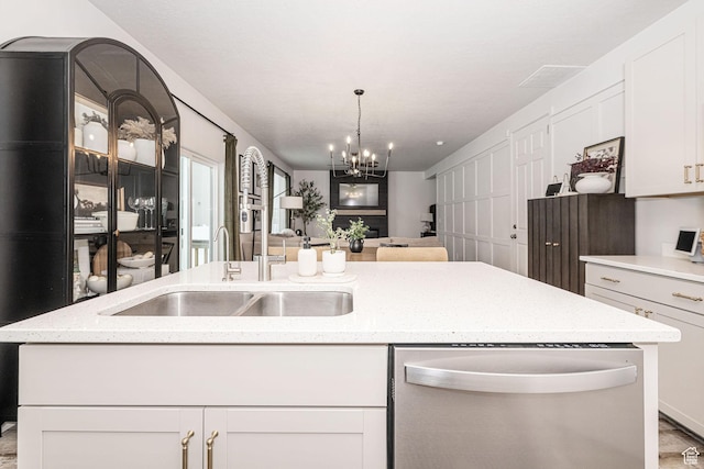 198 W Box Creek Dr, Stansbury Park, UT 84074 - kitchen with an inviting chandelier, stainless steel dishwasher, a sink, open floor plan, and white cabinetry