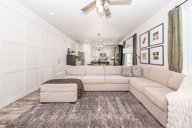 198 W Box Creek Dr, Stansbury Park, UT 84074 - living area with recessed lighting, ceiling fan with notable chandelier, and light wood-type flooring