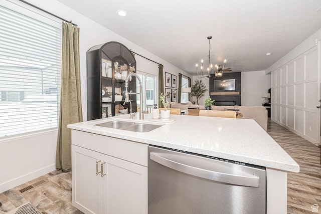 198 W Box Creek Dr, Stansbury Park, UT 84074 - kitchen featuring a sink, open floor plan, an island with sink, dishwasher, and light wood finished floors