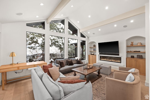 2651 E Hiawatha Cir, Salt Lake City, UT 84108 - living room featuring light wood finished floors, built in features, beamed ceiling, recessed lighting, and a glass covered fireplace