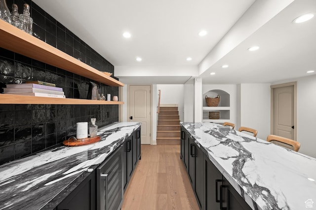 2651 E Hiawatha Cir, Salt Lake City, UT 84108 - kitchen featuring dark cabinetry, open shelves, and light stone counters