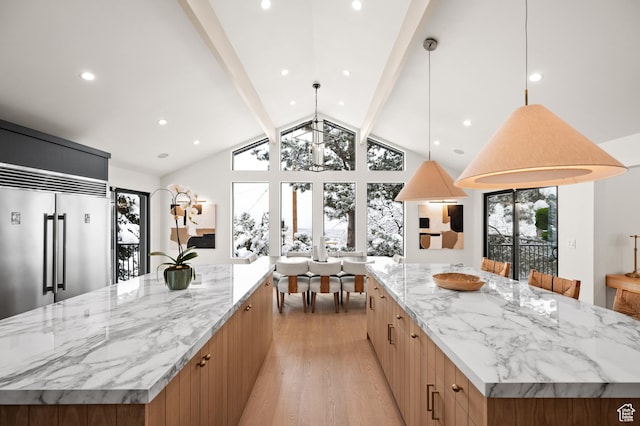 2651 E Hiawatha Cir, Salt Lake City, UT 84108 - kitchen with a large island, a wealth of natural light, modern cabinets, and built in refrigerator